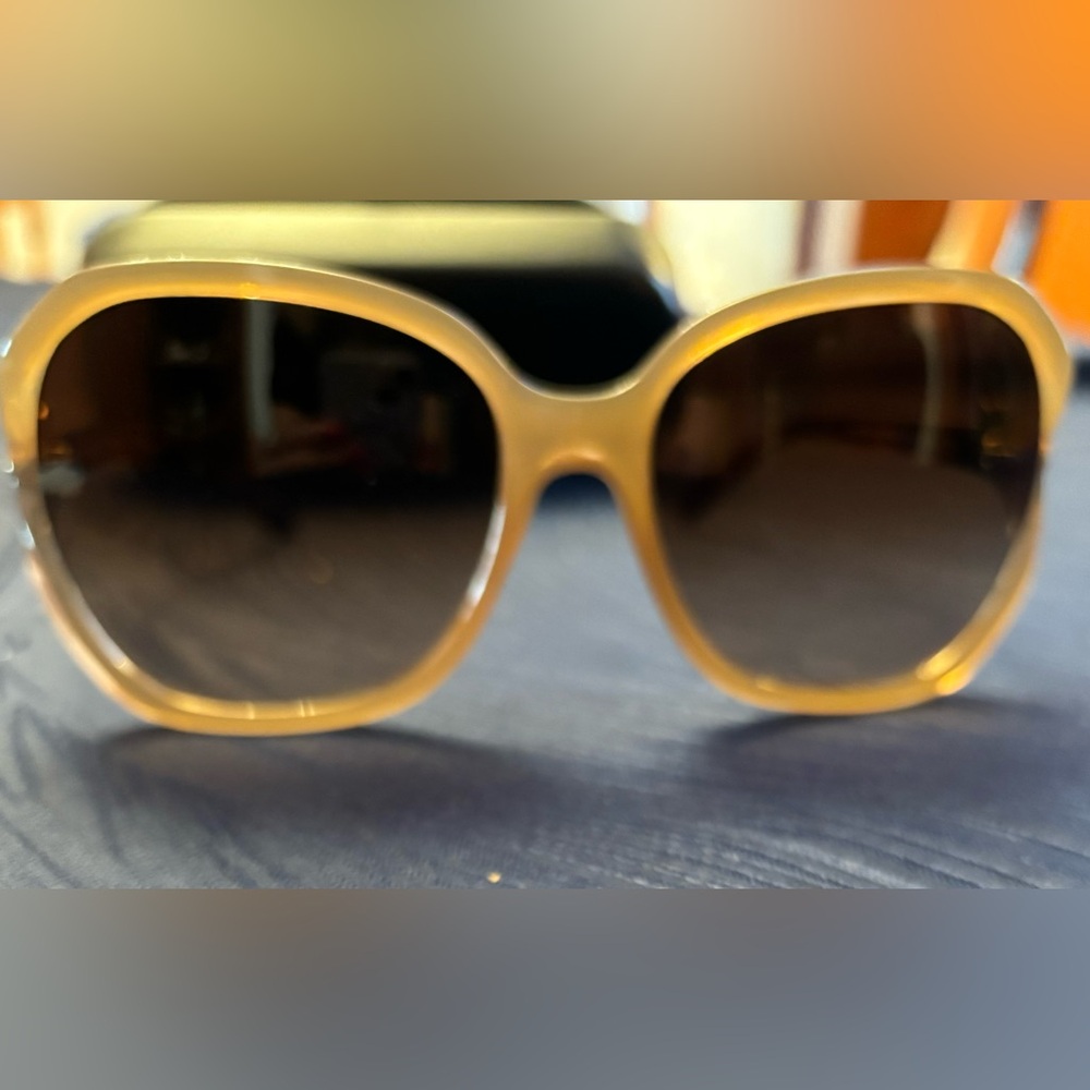 Coach butterfly sunglasses with decorative sides.